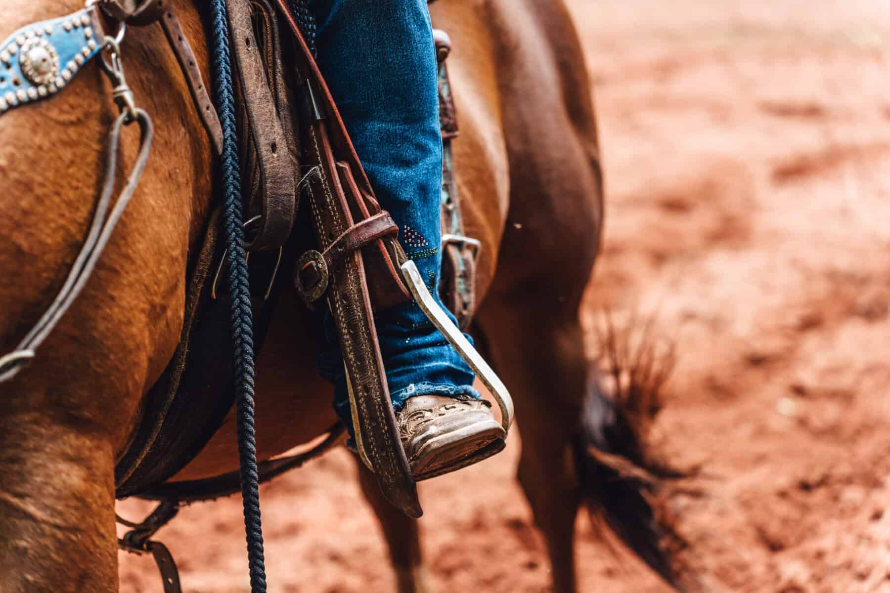 Close-up of boots in the horse’s stirrup